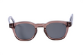 Sunglasses with a transparent brown frame and dark lenses on a white background